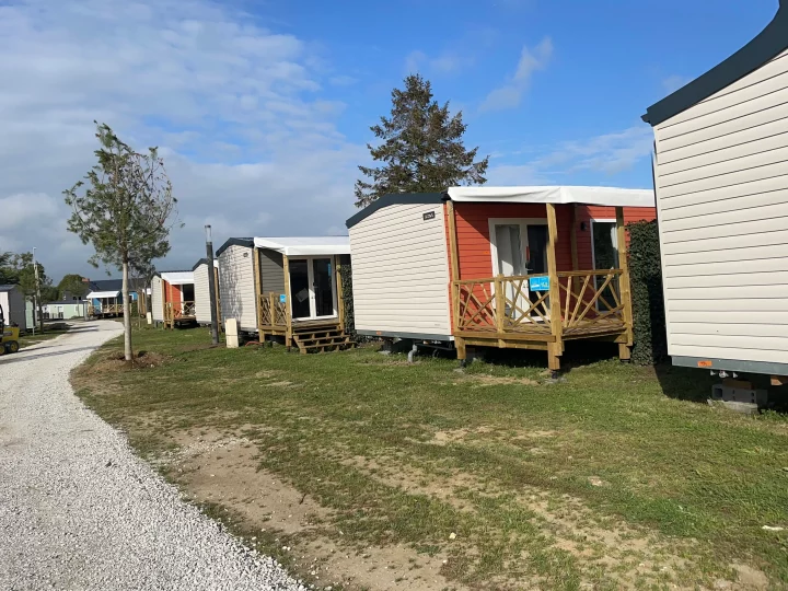 Mobil-homes alignés sur un terrain herbeux.